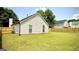 The backyard features lush green grass, new fencing, and the rear exterior of the home at 6638 Creek Turn Dr, Rex, GA 30273