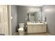 This bathroom features a dual sink vanity, a large mirror, a tile floor, and a standard toilet at 6638 Creek Turn Dr, Rex, GA 30273