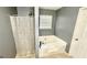 This bathroom features a combination shower and tub with a privacy window for natural light at 6638 Creek Turn Dr, Rex, GA 30273