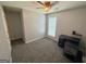 This bedroom features neutral-colored walls, soft carpet, a ceiling fan, and a privacy window at 6638 Creek Turn Dr, Rex, GA 30273