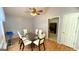 Elegant dining room featuring a glass table, seating for six, and modern lighting at 6638 Creek Turn Dr, Rex, GA 30273