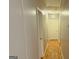 Clean hallway featuring neutral paint, wood floors, and simple, functional design at 6638 Creek Turn Dr, Rex, GA 30273