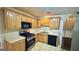 Functional kitchen with wood cabinetry, updated appliances, and a bright, clean aesthetic at 6638 Creek Turn Dr, Rex, GA 30273