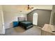 This main bedroom features neutral-colored walls, soft carpet, a ceiling fan, and an arched window at 6638 Creek Turn Dr, Rex, GA 30273