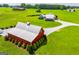 Expansive rural property featuring a red barn, modern farmhouse, and lush green lawns at 385 Liberty Church Rd, Carrollton, GA 30116
