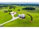 Overhead view of the modern farmhouse and barn nestled within a sprawling green landscape at 385 Liberty Church Rd, Carrollton, GA 30116