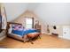 Charming attic bedroom with hardwood floors, a window, and a comfortable bed at 385 Liberty Church Rd, Carrollton, GA 30116