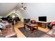 Cozy attic living area with hardwood floors, sofas, and a ceiling fan at 385 Liberty Church Rd, Carrollton, GA 30116