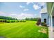 Expansive backyard featuring lush green grass and well-maintained landscaping, with views of neighboring properties at 385 Liberty Church Rd, Carrollton, GA 30116