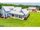 Beautiful backyard with a covered patio, grill and lush landscaping surrounding a modern farmhouse at 385 Liberty Church Rd, Carrollton, GA 30116