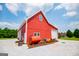 Side view of barn with white garage door, gravel driveway, and an orange tank in the front of it at 385 Liberty Church Rd, Carrollton, GA 30116