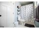 Bathroom with white fixtures including toilet and shower/tub combo with arrow patterned shower curtain at 385 Liberty Church Rd, Carrollton, GA 30116