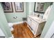 Well-lit powder room featuring vanity with granite countertop, modern fixtures, and tile floor at 385 Liberty Church Rd, Carrollton, GA 30116