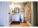 A bathroom with a toilet, cabinet, mirror, a picture and a shower curtain at 385 Liberty Church Rd, Carrollton, GA 30116