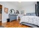 Cozy bedroom with hardwood floors, dresser, decorative mirror, and a comfortable bed setting at 385 Liberty Church Rd, Carrollton, GA 30116