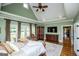 Spacious bedroom with TV, tray ceilings, hardwood floors and direct access to ensuite bath at 385 Liberty Church Rd, Carrollton, GA 30116