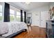 Bright bedroom with large windows, hardwood floors, and a neutral color scheme, creating a serene space at 385 Liberty Church Rd, Carrollton, GA 30116