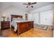 Spacious bedroom with hardwood floors, closet, and a plush bed, creating a welcoming atmosphere at 385 Liberty Church Rd, Carrollton, GA 30116