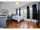 Charming bedroom with hardwood floors, neutral walls, and large windows offering great natural light at 385 Liberty Church Rd, Carrollton, GA 30116