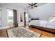 Inviting bedroom featuring hardwood floors, a rocking chair, and a comfortable bed under an angled ceiling at 385 Liberty Church Rd, Carrollton, GA 30116