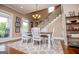 Well-lit dining area with a staircase, a view to the back, and modern finishes at 385 Liberty Church Rd, Carrollton, GA 30116