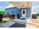 Charming entrance featuring a concrete porch, blue siding, and trimmed flower beds at 385 Liberty Church Rd, Carrollton, GA 30116