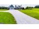 Inviting two-car garage and covered porch entrance with beautiful gravel driveway leading to a modern farmhouse at 385 Liberty Church Rd, Carrollton, GA 30116