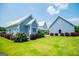 Charming home with a backyard and beautiful landscaping and a light blue exterior on a sunny day at 385 Liberty Church Rd, Carrollton, GA 30116