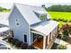 Attractive side view of a home with a metal roof, front porch, and lush green lawn at 385 Liberty Church Rd, Carrollton, GA 30116