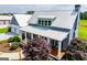Stunning home featuring a metal roof, inviting front porch, and beautifully landscaped yard at 385 Liberty Church Rd, Carrollton, GA 30116
