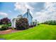 Side view of a charming home showing the well-manicured lawn and landscaping at 385 Liberty Church Rd, Carrollton, GA 30116