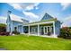 Exterior view of a blue home with a covered patio and a large grassy yard at 385 Liberty Church Rd, Carrollton, GA 30116