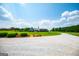 Beautiful home with well-manicured lawn, decorative shrubs and stone driveway on a sunny day at 385 Liberty Church Rd, Carrollton, GA 30116