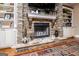 Cozy stone fireplace with built-in shelving and decorative accents at 385 Liberty Church Rd, Carrollton, GA 30116