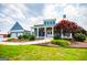 Charming two-story home with a covered porch, manicured landscaping, and a detached garage at 385 Liberty Church Rd, Carrollton, GA 30116