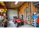 Garage with ATV, ladders, tools, and shelves on the walls at 385 Liberty Church Rd, Carrollton, GA 30116