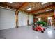 Large garage space with tractor, tools, multiple roll-up doors and wooden rafters at 385 Liberty Church Rd, Carrollton, GA 30116