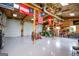 Large garage space with tractor, tools, and multiple American and military themed flags at 385 Liberty Church Rd, Carrollton, GA 30116