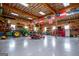 Large garage space with tractor, tools, and multiple American and military themed flags at 385 Liberty Church Rd, Carrollton, GA 30116
