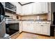 Kitchen area featuring stainless steel appliances, with light colored cabinets at 385 Liberty Church Rd, Carrollton, GA 30116