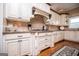 Gourmet kitchen featuring custom cabinets, granite countertops, and stainless steel appliances at 385 Liberty Church Rd, Carrollton, GA 30116