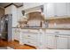This kitchen features a stainless steel refrigerator, granite countertops, and custom cabinets at 385 Liberty Church Rd, Carrollton, GA 30116