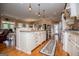 Large, open kitchen features granite countertops, stainless steel appliances, and a center island at 385 Liberty Church Rd, Carrollton, GA 30116