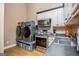 Laundry and Kitchen area featuring gray front load machines and stainless steel appliances at 385 Liberty Church Rd, Carrollton, GA 30116