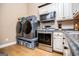 Laundry and Kitchen area featuring gray front load machines and stainless steel appliances at 385 Liberty Church Rd, Carrollton, GA 30116