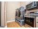 Laundry and Kitchen area featuring gray front load machines and stainless steel appliances at 385 Liberty Church Rd, Carrollton, GA 30116