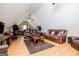 Cozy living room featuring leather couches, hardwood floors and ceiling fan in a well-lit room at 385 Liberty Church Rd, Carrollton, GA 30116