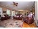 Bright and open living room featuring hardwood floors and plush leather furniture at 385 Liberty Church Rd, Carrollton, GA 30116