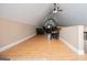 Large room with hardwood floors, trim, ceiling fans, and a bar for entertaining at 385 Liberty Church Rd, Carrollton, GA 30116
