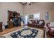 Spacious living room with hardwood floors, office area, leather couch, and natural light at 385 Liberty Church Rd, Carrollton, GA 30116